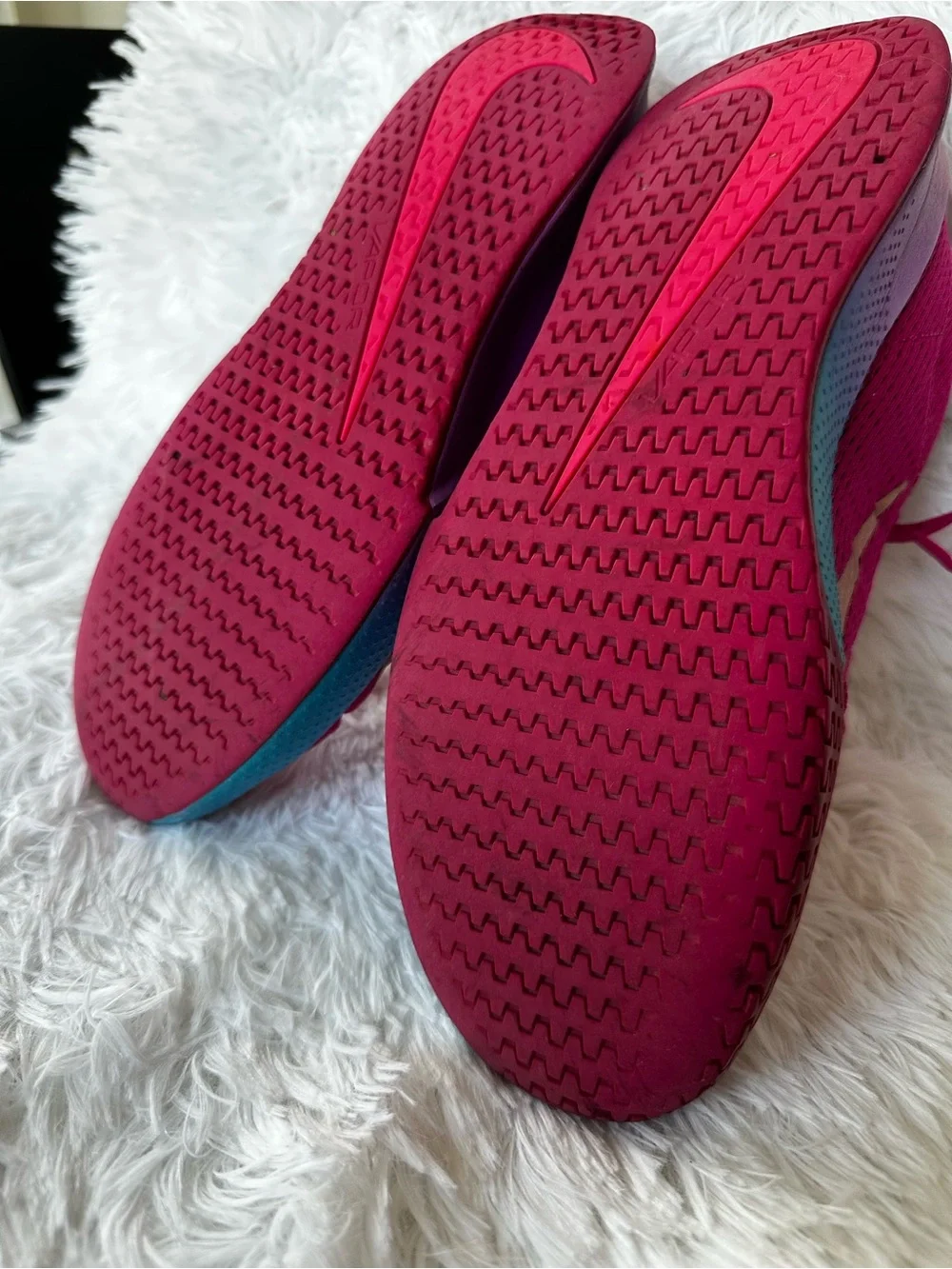 Nike Women's Bold Pink Athletic Court Shoes with Teal Purple Gradient Accent.